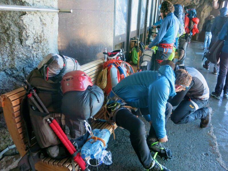 Mountaineers preparing at the Aiguille du Midi. Image © PlanetSKI
